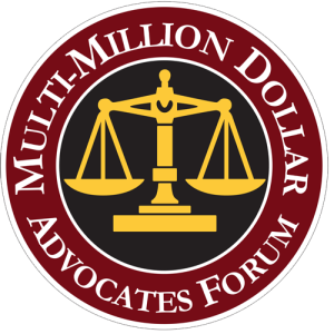 Round logo of the multi-million dollar personal injury advocates forum featuring a gold scale on a maroon background, encircled by the organization's name in gold lettering.