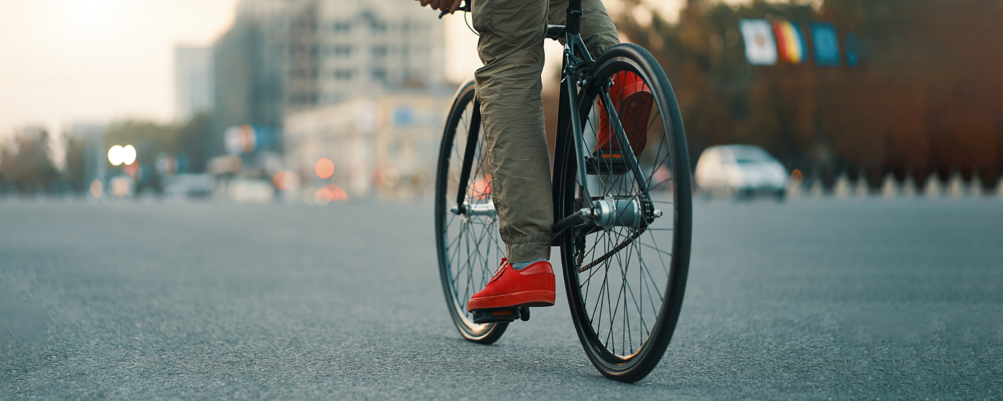 closeup of casual man legs riding classic bike