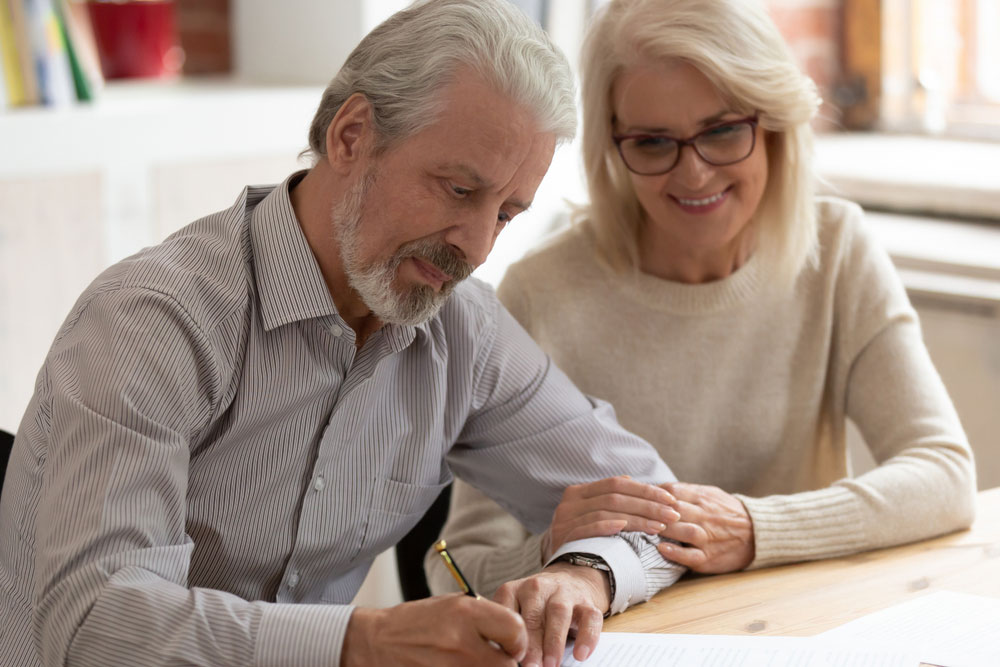 older couple completing documents