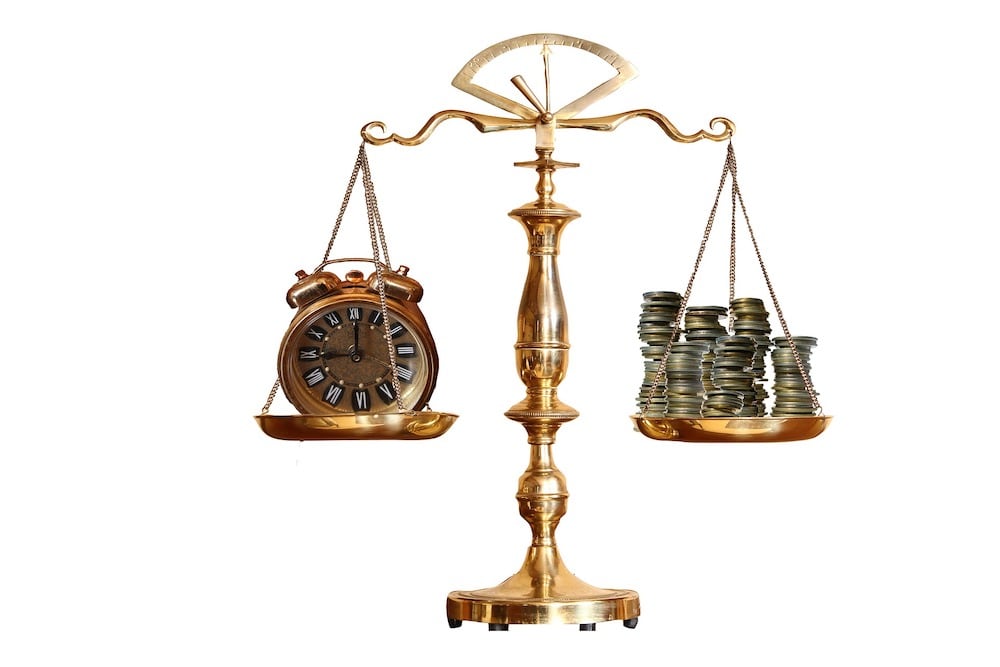 clock and money on scale
